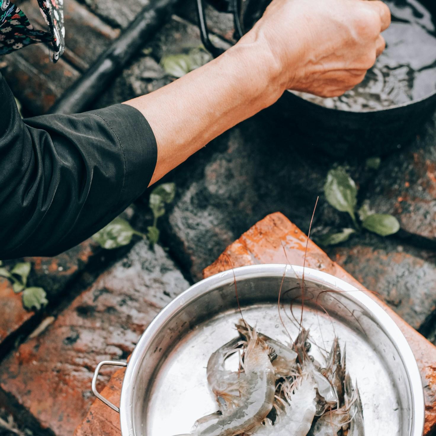 Diverse group of community members sharing a meal together, showcasing the social bonds formed through collaborative cooking